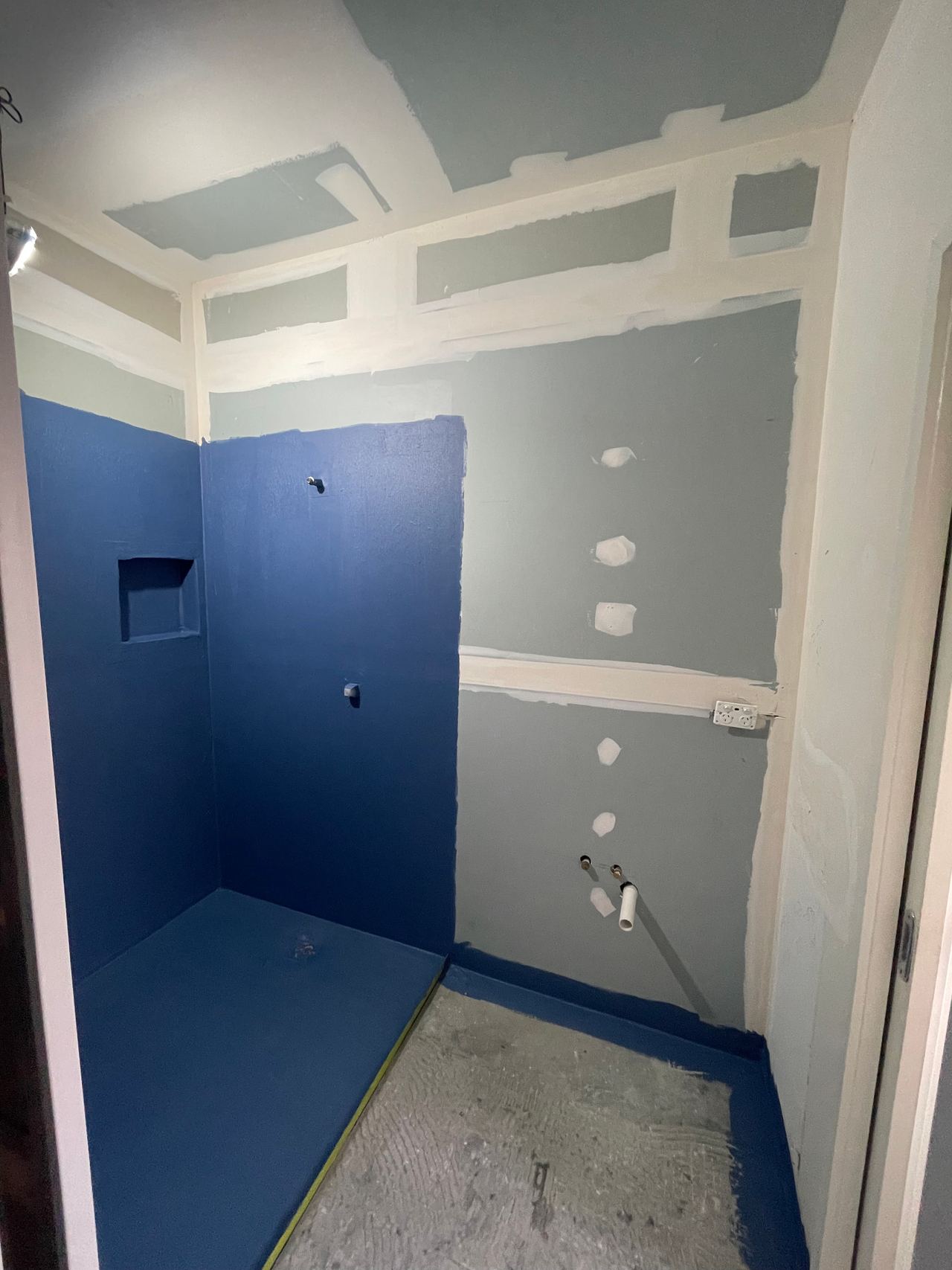 During: blue waterproofing membrane applied to the shower walls and floor before tiling in Cranbourne West